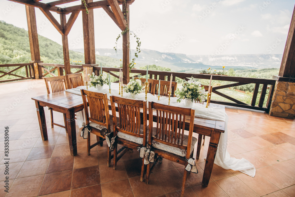 Decorated wedding table for the newlyweds and guests with mountain views. Wedding decor and Floristics.