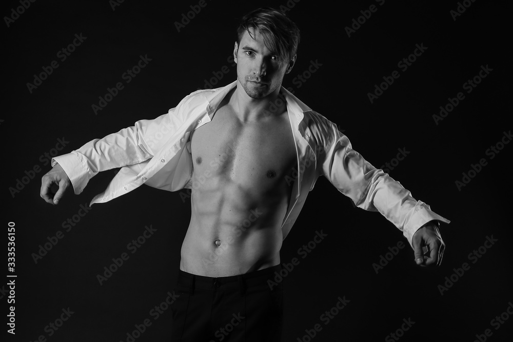 Black and white photo portrait of young man dressed in shirt. sexy man