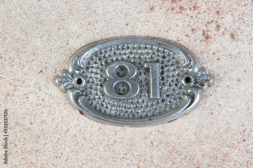 Old aluminum number on concrete background Old aluminum number on concrete background
