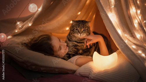 woman with cat in bed