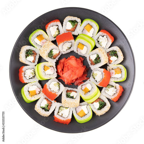 set of tasty rolls on a black plate for the restaurant menu on a white background