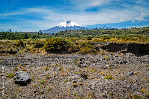 View of the Cotopaxi volcano on a sunny morning  with volcanic rocks in the foreground. Cotopaxi National Park  Ecuador