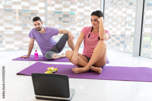 healthy boy and girl couple doing sport indoors bright and white