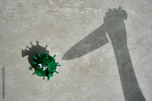 Conceptual shadow of knife going to kill a green virus