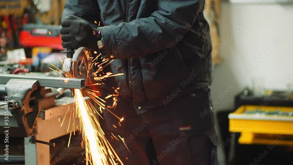 Angle Grinder Cutting Metal at Workshop