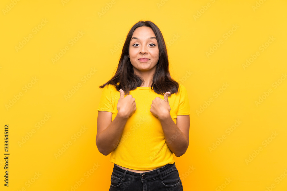 Young brunette girl over isolated background with surprise facial expression