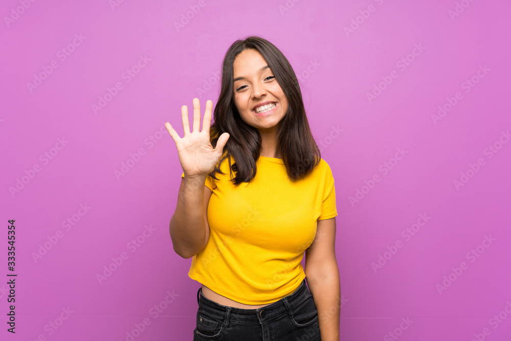 Young brunette girl over isolated background counting five with fingers Young brunette girl over isolated background counting five with fingers