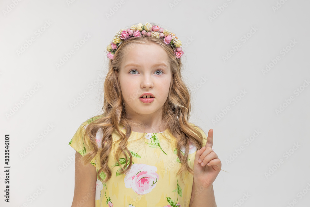 Closeup portrait of serious pretty pretty teen girl pointing with index finger and looking at camera isolated on white background. Positive emotions facial expression, signs Closeup portrait of serious pretty pretty teen girl pointing with index finger and looking at camera isolated on white background. Positive emotions facial expression, signs