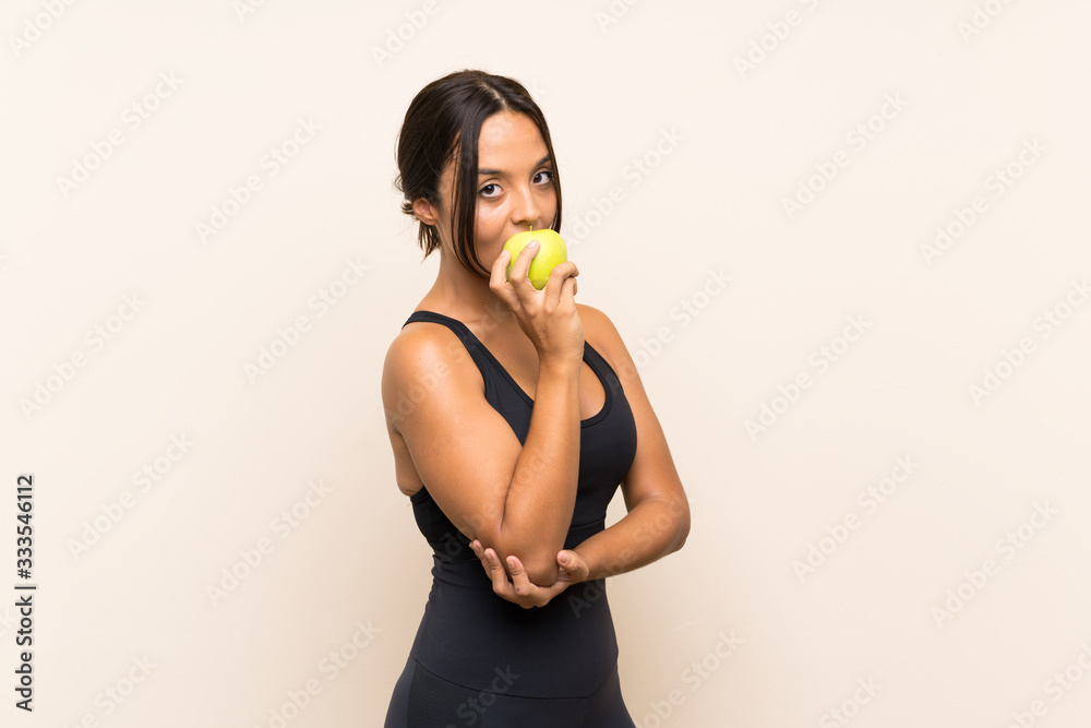Young brunette girl with an apple over isolated background Young brunette girl with an apple over isolated background