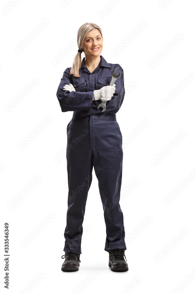 Female worker in a uniform holding a wrench Female worker in a uniform holding a wrench