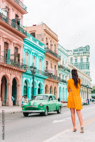Tourist girls in popular area in Havana, Cuba. Young woman traveler smiling