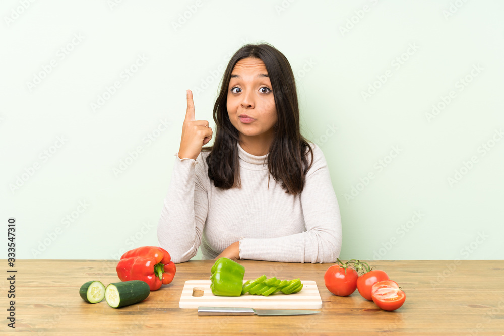 Young brunette woman with vegetables pointing with the index finger a great idea Young brunette woman with vegetables pointing with the index finger a great idea