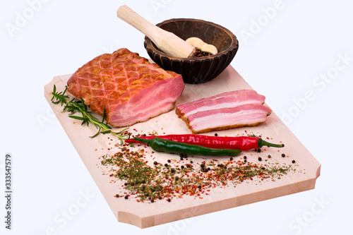 Bacon on a wooden plate with peperoni photo