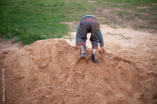 The child plays in the sandbox.