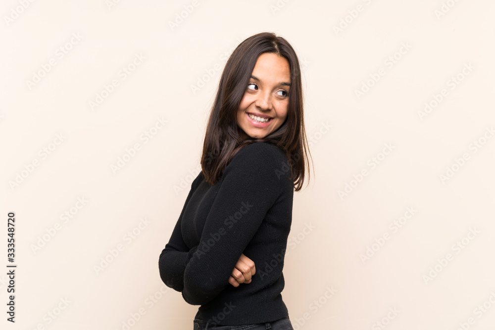 Young brunette woman with white sweater over isolated background with arms crossed and happy Young brunette woman with white sweater over isolated background with arms crossed and happy