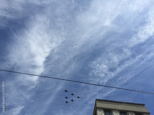 during military parade in Moscow military planes fly in formation in the blue sky