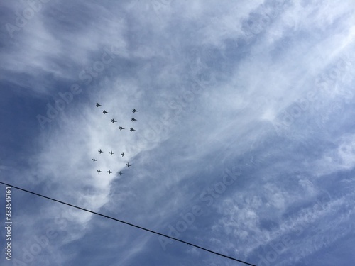 during military parade in Moscow military planes fly in formation in the blue sky