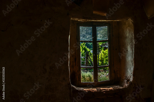 Old rural abandoned house window view fom inside © varbenov