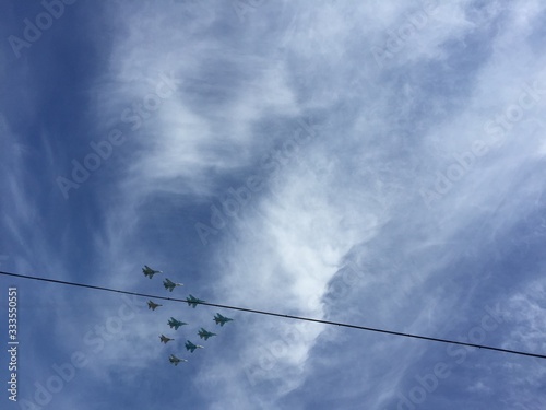 during military parade in Moscow military planes fly in formation in the blue sky