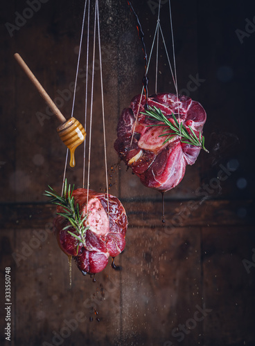 Raw meat ossobuco with honey, sause and rosemary