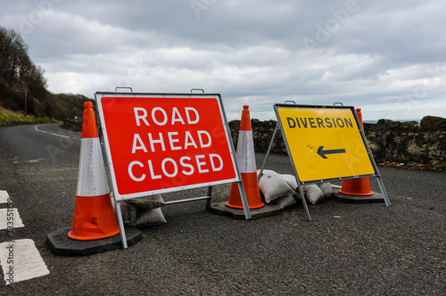 Road closed signs on a coastal road