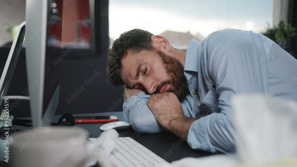 Fototapeta premium Fun office worker going crazy of alcohol lying on the floor and laughing hard. Drunk addicted business manager getting up sitting in chair. Alcohol intoxication.