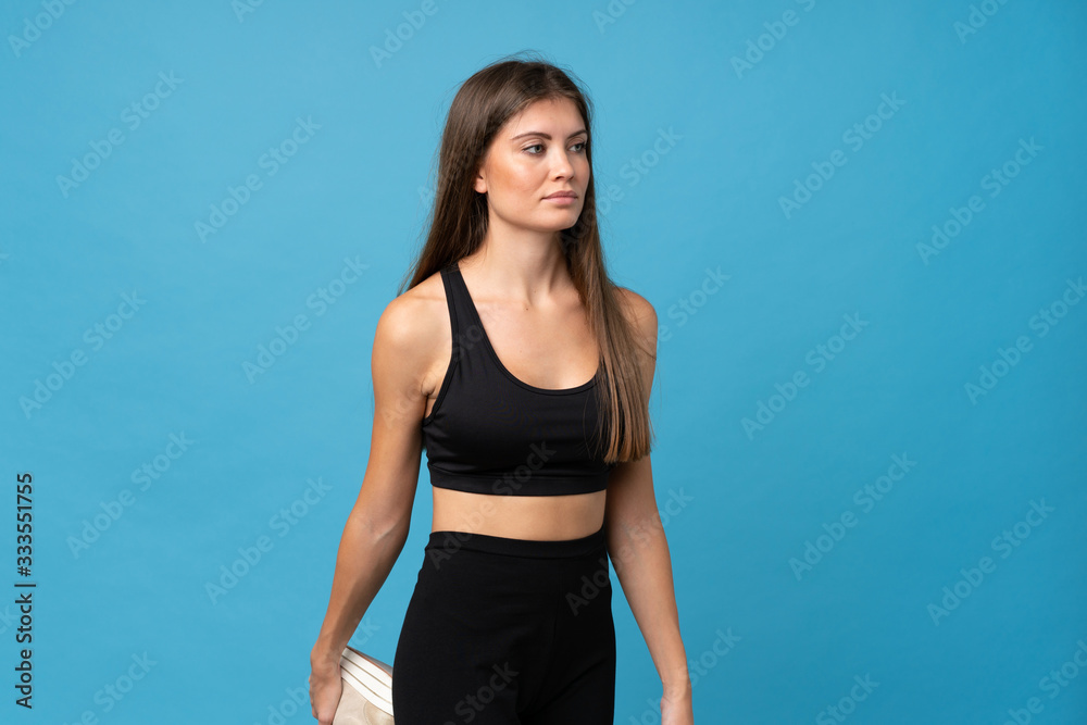 Young girl woman over isolated background stretching leg Young girl woman over isolated background stretching leg