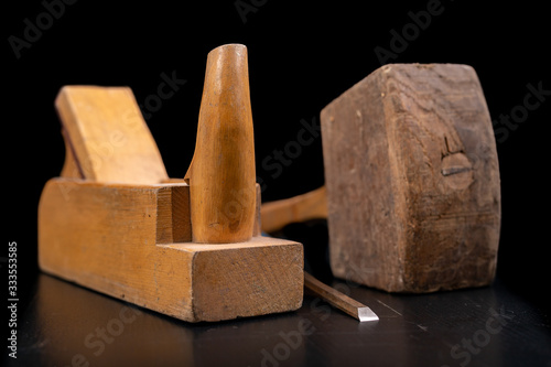 Fototapeta Naklejka Na Ścianę i Meble -  Joiner's planer, wooden hammer and chisel. Carpentry accessories in the workshop.