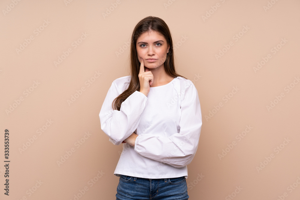 Young girl over isolated background Looking front Young girl over isolated background Looking front