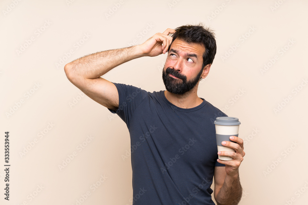 Man with beard holding a coffee having doubts and with confuse face expression Man with beard holding a coffee having doubts and with confuse face expression