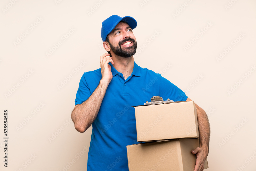 Delivery man with beard over isolated background thinking an idea Delivery man with beard over isolated background thinking an idea