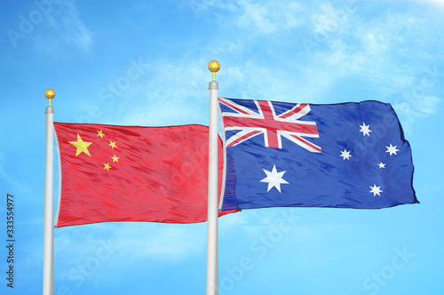 Canvas Print China and Australia two flags on flagpoles and blue cloudy sky