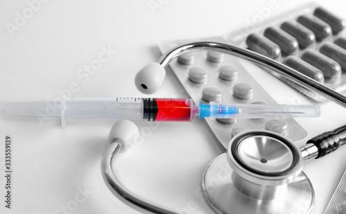 Pharmacy and medical supplies on a white background. Vaccine and medications for treatment of diseases, flu and coronavirus epidemics. Epidemic novel coronavirus COVID-19