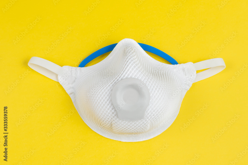 ffp2 mask on yellow background for protect droplets infectious disease from infectious people. Face mask protection against pollution, virus, flu and coronavirus. ffp2 mask on yellow background for protect droplets infectious disease from infectious people. Face mask protection against pollution, virus, flu and coronavirus.