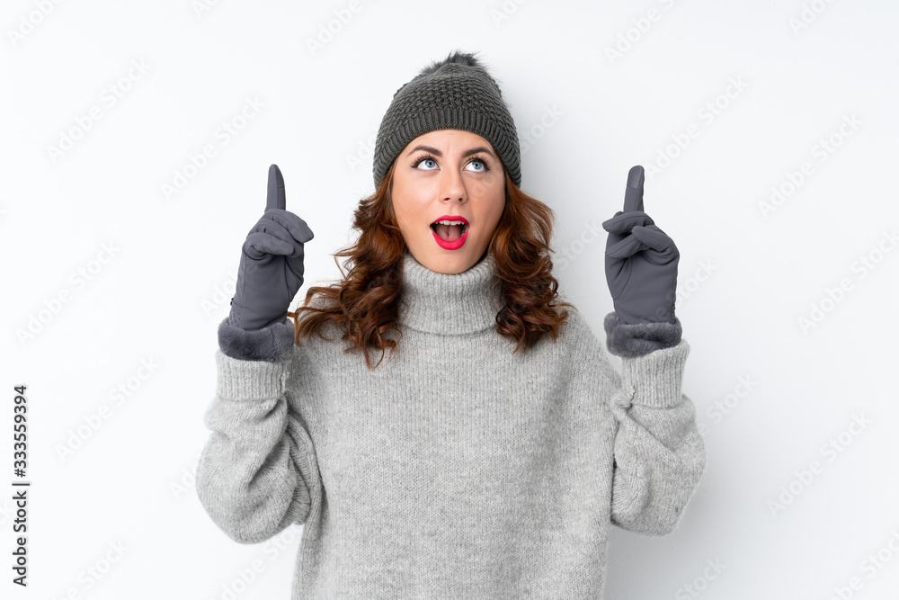 Young Russian woman with winter hat over isolated white background pointing with the index finger a great idea Young Russian woman with winter hat over isolated white background pointing with the index finger a great idea