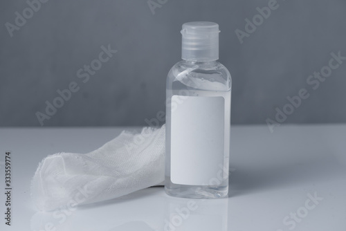 White gauze and antiseptic gel on white, gray background
