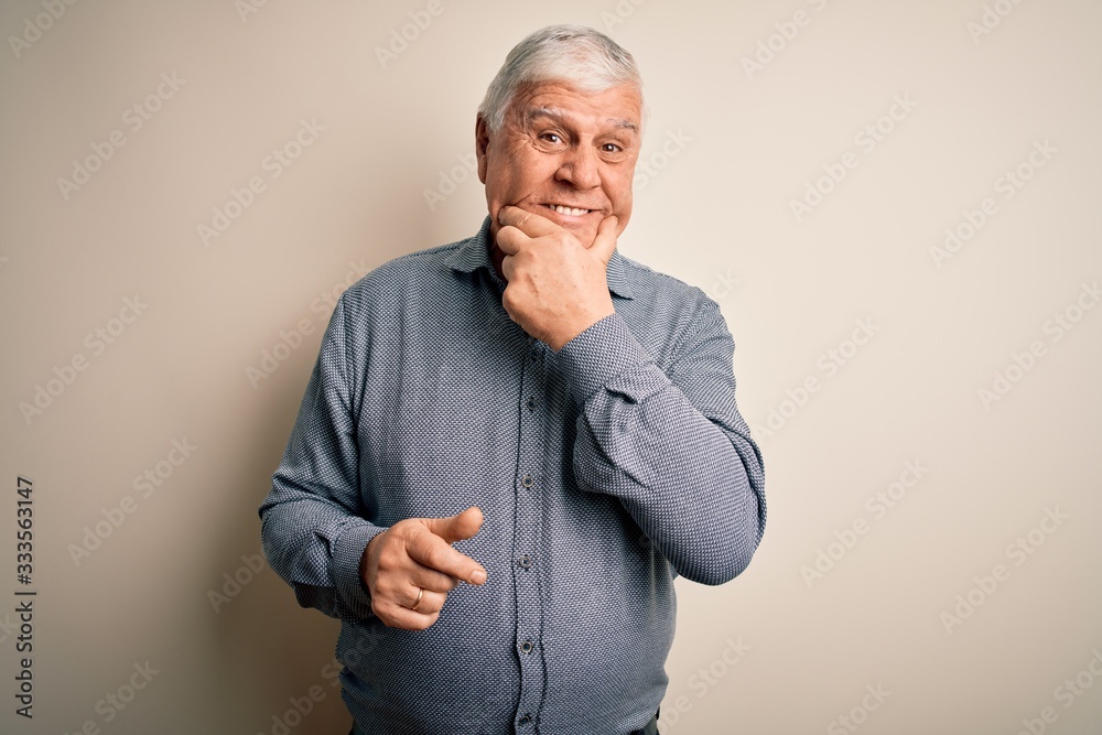 Senior handsome hoary man wearing casual shirt standing over isolated white background looking confident at the camera smiling with crossed arms and hand raised on chin. Thinking positive.