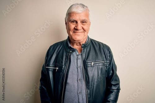 Senior handsome hoary man wearing casual shirt and jacket over isolated white background with a happy and cool smile on face. Lucky person.