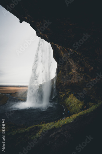 View of a waterfall from behind in Iceland