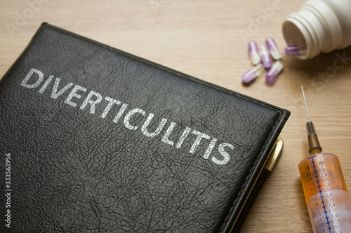 Book about Diverticulitis and medication, injection, syringe and pills photo