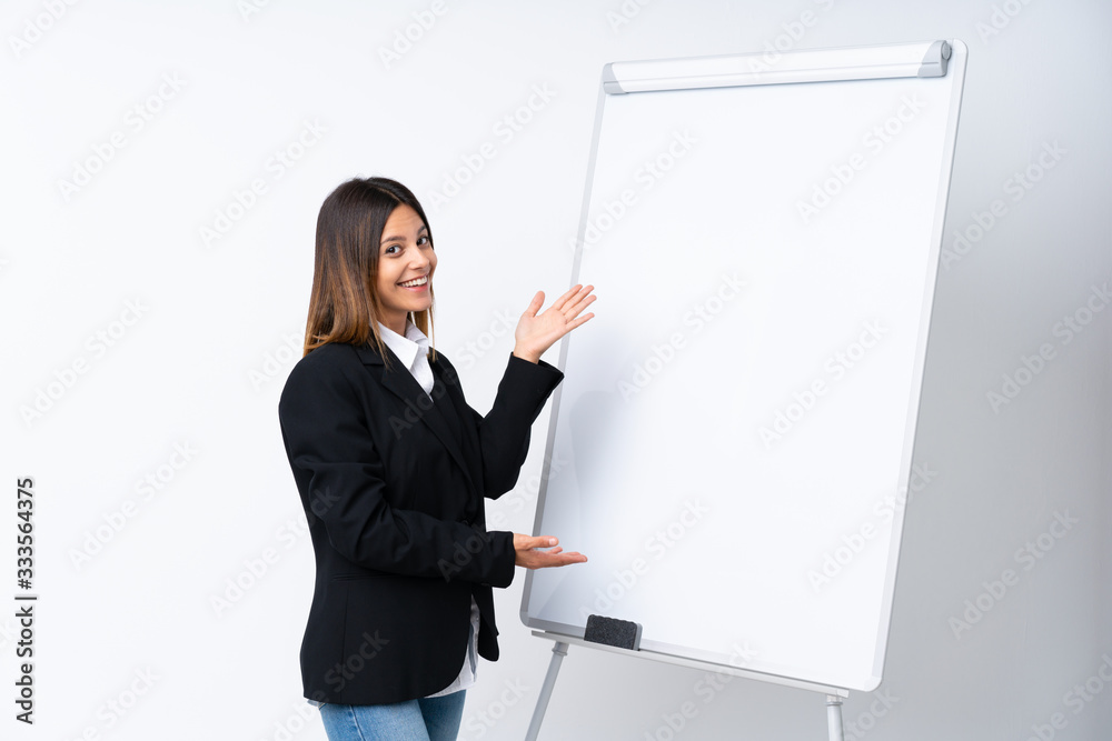Young woman giving a presentation on white board giving a presentation on white board Young woman giving a presentation on white board giving a presentation on white board