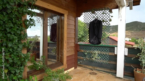 Wedding suit, groom dress, amazing tuxedo in harmony with a beautiful landscape reflected in a mirror