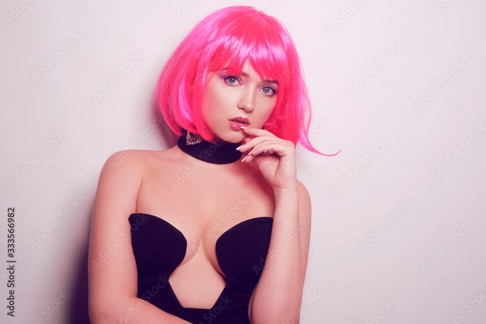 Girl on a white background posing, professional model. The girl with pink hair, mysterious, beautiful, looks at the camera, flirts, flirts. Long pink earrings. Incredible look. Girl on a white background posing, professional model. The girl with pink hair, mysterious, beautiful, looks at the camera, flirts, flirts. Long pink earrings. Incredible look.