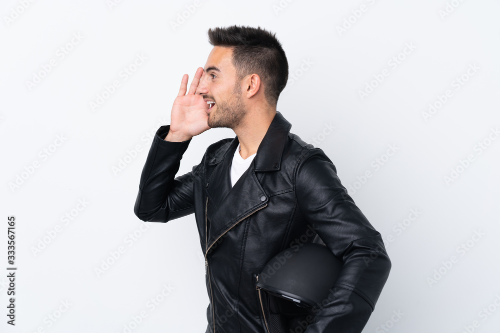 Man with a motorcycle helmet shouting with mouth wide open to the lateral Man with a motorcycle helmet shouting with mouth wide open to the lateral