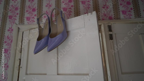wedding purple shoes hanging over the door