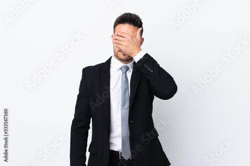 Young business man over isolated background covering eyes by hands