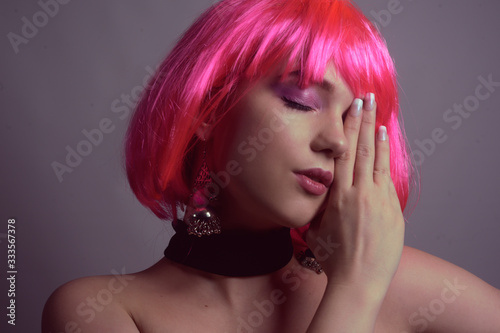 orgeous french manicure on a bright girl with pink hair. Fashion photo of a model with beautiful hands  and long nails. Girl with professional pink make-up.