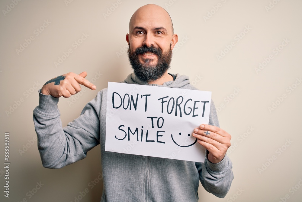 Handsome bald man with beard holding banner with funny positive message with surprise face pointing finger to himself Handsome bald man with beard holding banner with funny positive message with surprise face pointing finger to himself