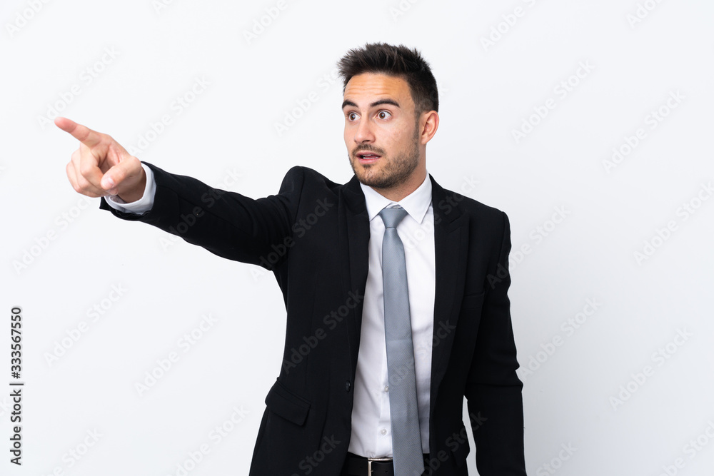 Young business man over isolated background pointing away Young business man over isolated background pointing away