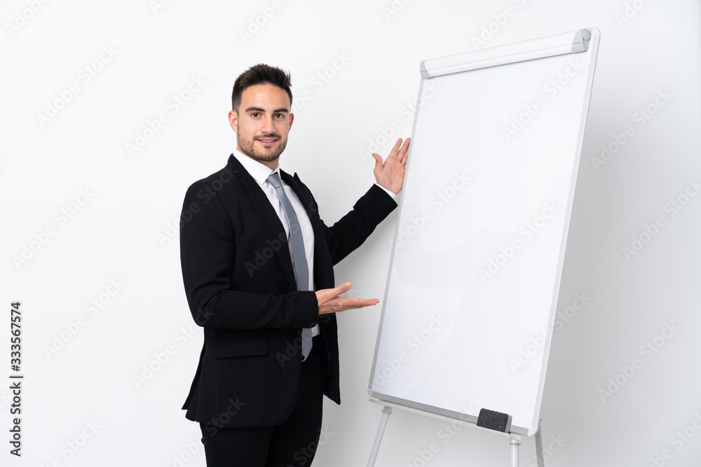 Young man giving a presentation on white board Young man giving a presentation on white board